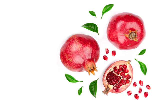 istock pomegranate with leaves isolated on white background with copy space for your text. Top view. Flat lay pattern 947127866
