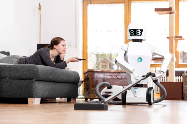 auditorium Er velkendte renovere Woman Is Enjoying Her Leisure While A Robot Is Doing The Work In The  Household Aai Is Vacuuming The Floor Stock Photo - Download Image Now -  iStock