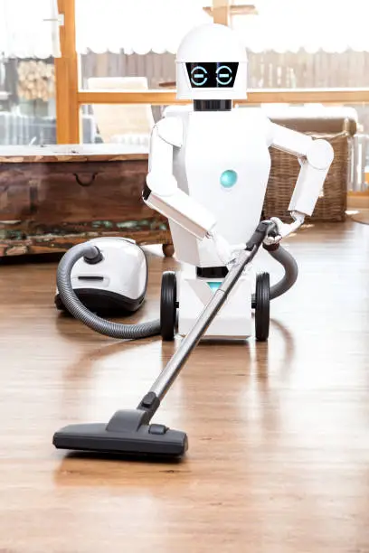 ambient assisted living roboter is vacuuming the floor of the living room