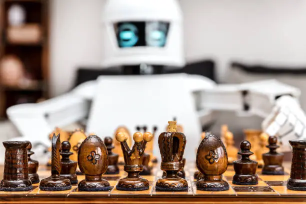 autonomous cyborg or roboter is playing chess, concept strategy or adaptive ki with chess computer