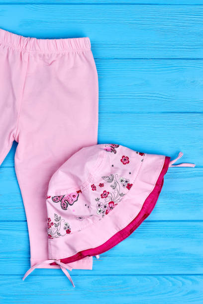 istock Pink pants and hat for infant girl. 947133690
