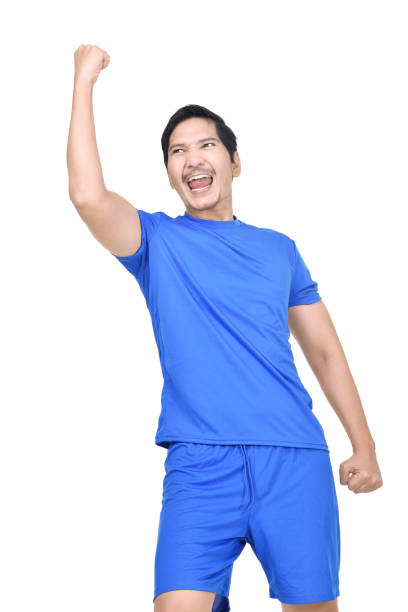 istock Joyful asian footballer celebrates win 947136800