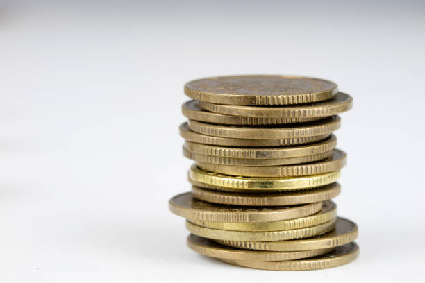 istock Coins stacked. Money lying on the table. White background. 947140994