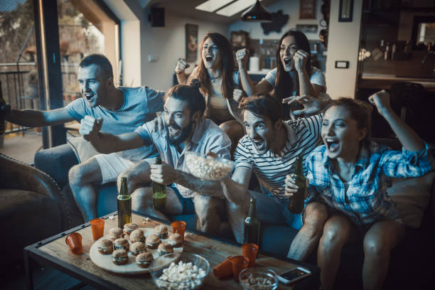 istock Excited fans having fun while cheering for their team at home. 947141396