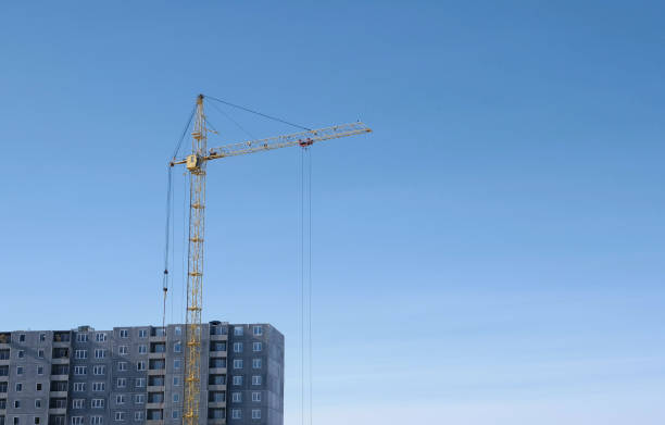 istock Construction of a multi-storey building. Crane on sky background. 947144456