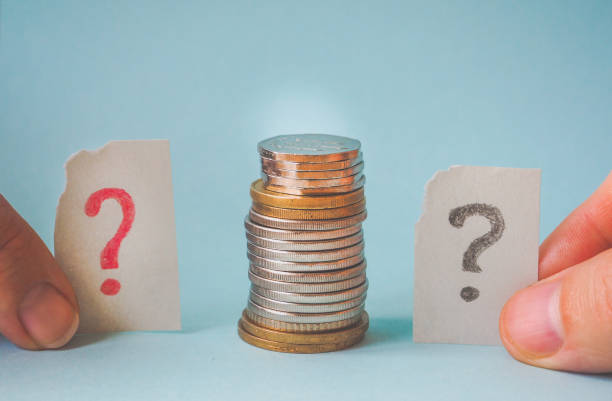istock Money coin in hand and a question mark. 947147740