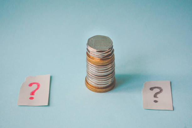 istock Money coin in hand and a question mark. 947147804
