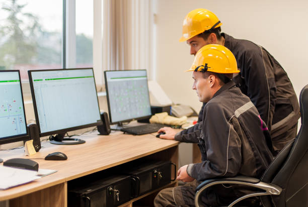 istock Field service engineers inspect relay protection system with laptop computer 947147928