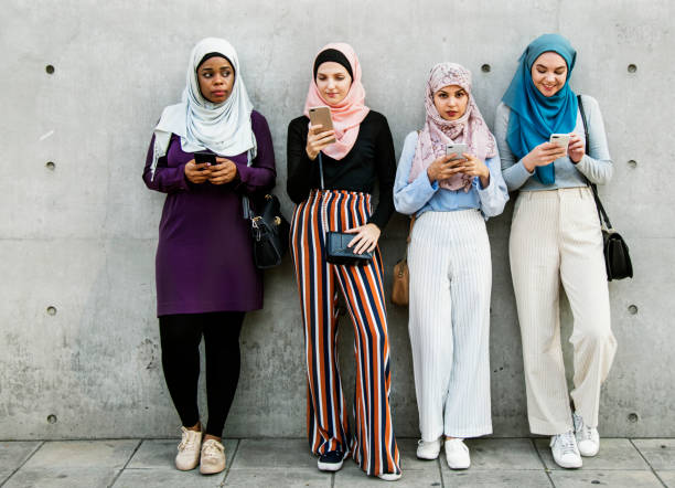 Group of islamic girls using smart phone Group of islamic girls using smart phone arabic girl stock pictures, royalty-free photos & images