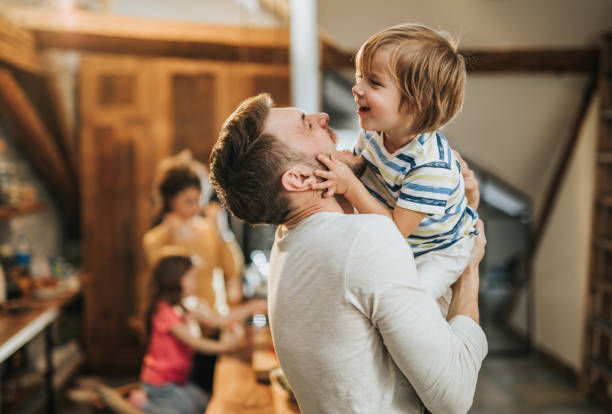 istock Cheerful father having fun with his little son at home. 947151570