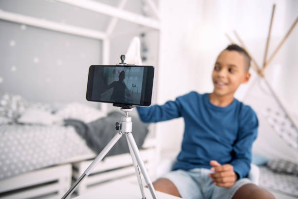istock Joyful boy blogger creating video 947151588