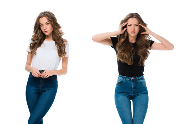 istock confident and exhausted twins looking at camera isolated on white 947151610