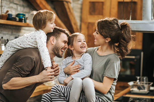 istock Cheerful family communicating during morning time in the kitchen. 947152374
