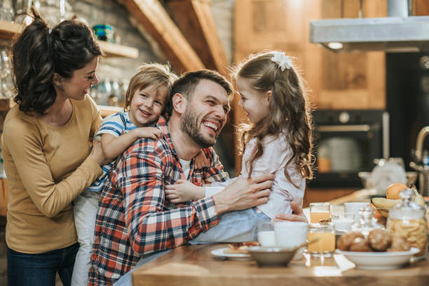 istock Young happy parents having fun with their children during breakfast time in the kitchen. 947155592
