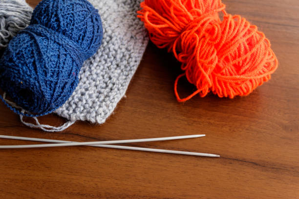 istock Woolen thread, knitting, knitting needles on wooden table 947155906