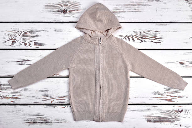 istock Knitted beige kardigan for kids. 947157396