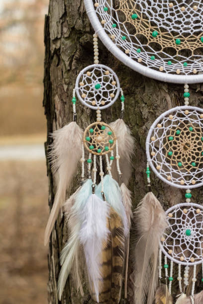 istock Handmade dream catcher with feathers threads and beads rope hanging 947163458