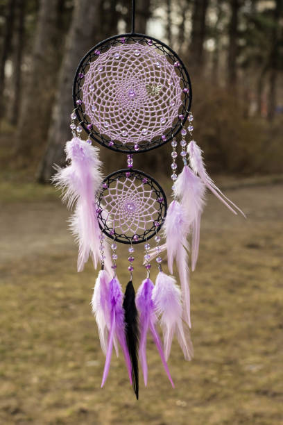 istock Handmade dream catcher with feathers threads and beads rope hanging 947163776