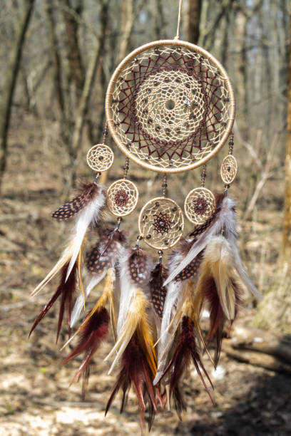 istock Handmade dream catcher with feathers threads and beads rope hanging 947164094