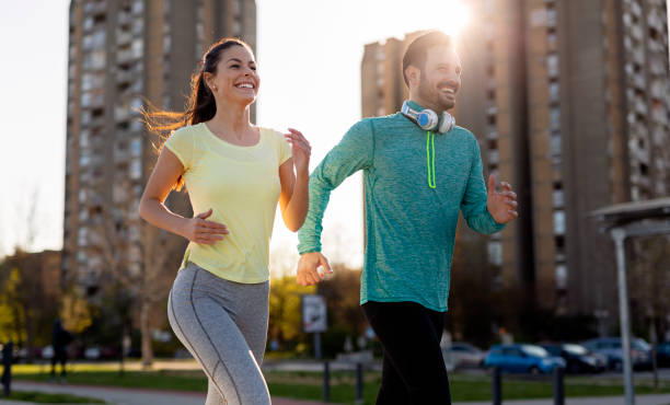 istock Attractive man and beautiful woman jogging together 947164146