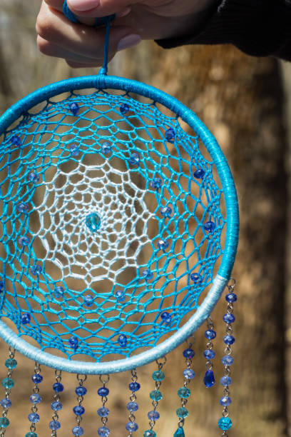 istock Handmade dream catcher with feathers threads and beads rope hanging 947164298