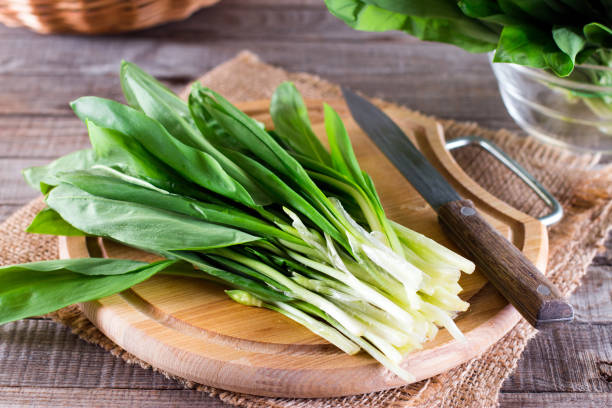 Ramson or wild garlic on a cutting board Ramson or wild garlic on a cutting board on the table wild garlic leaves stock pictures, royalty-free photos & images