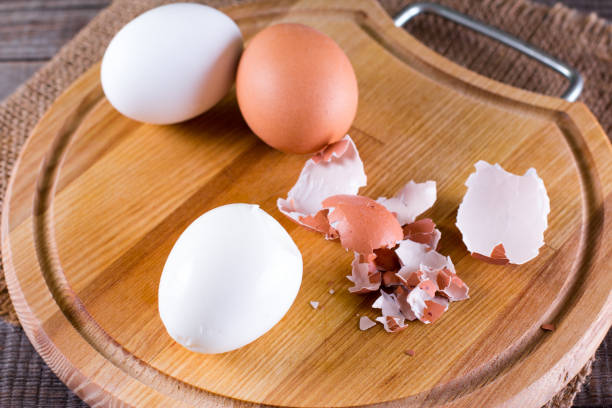 istock Peeled boiled eggs on wooden background 947170882
