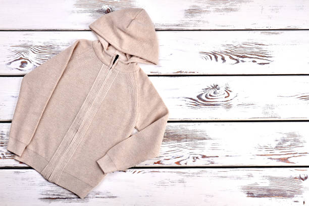 istock Beige knitted hooded sweater. 947170934