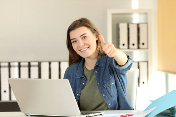 istock Satisfied intern with thumbs up at office 947174882