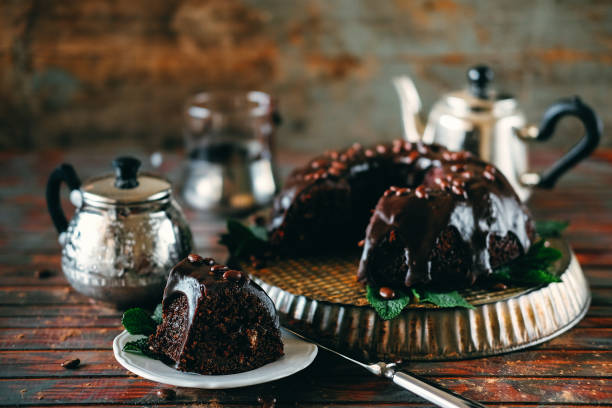 istock Sweet chocolate cake with cacao icing and decorated with mint and chocolate drops 947177754