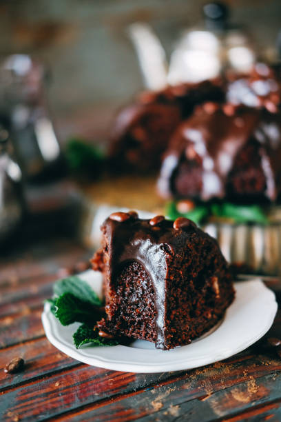 istock Sweet chocolate cake with cacao icing and decorated with mint and chocolate drops 947177792