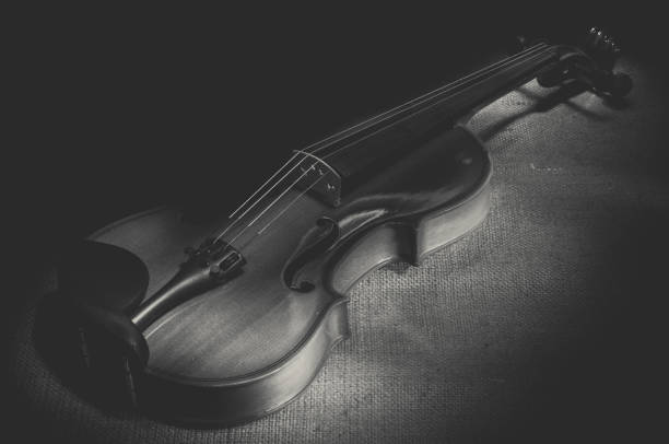 istock Violin musical instruments of orchestra closeup on black 947178212