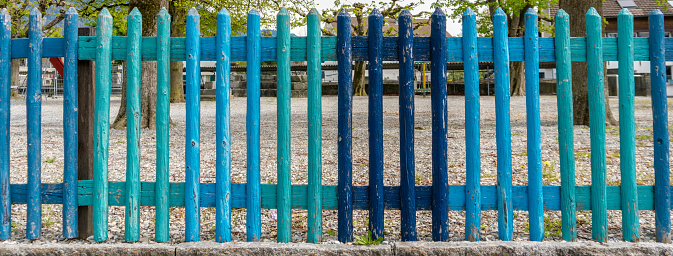 colorful wooden fence in different shades of blue panoramic view