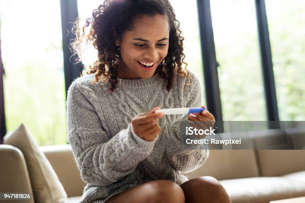 Woman With A Pregnancy Test Stock Photo - Download Image Now - Pregnancy Test, Women, Happiness