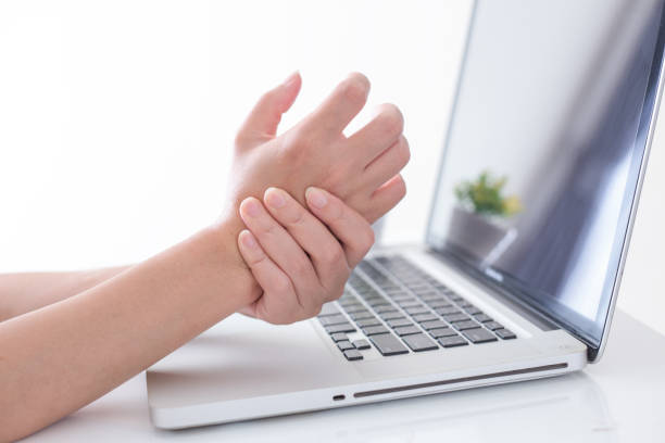 istock Woman holding her wrist pain from using computer. Office syndrome 947184926