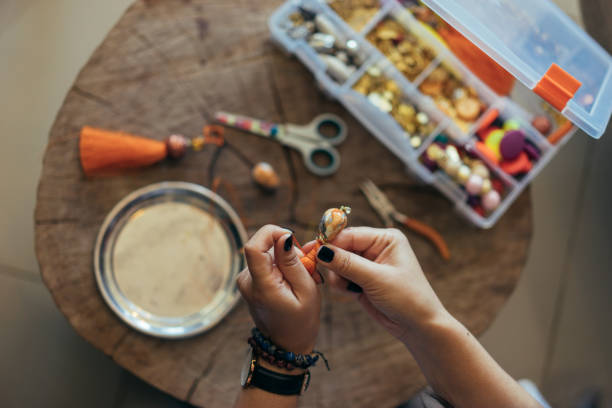 istock Young woman making jewelry 947188264