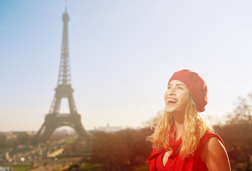 horizontal shot of happy tourist woman in Paris enjoying her city break.