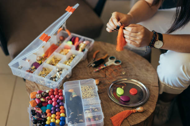 istock Young woman making jewelry 947188654