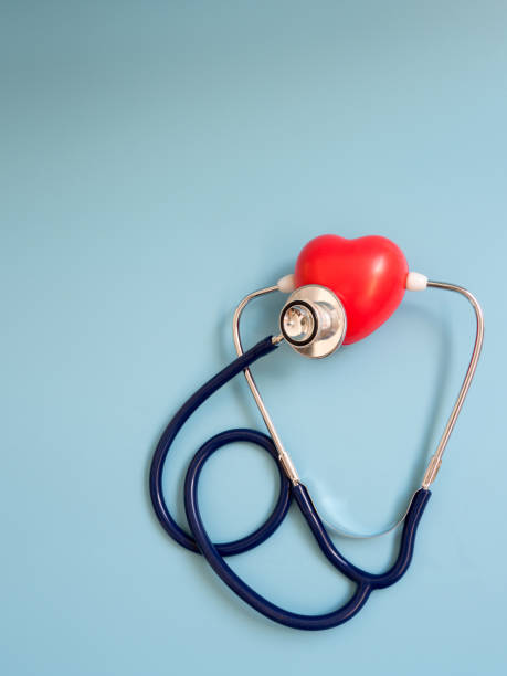 istock red heart using deep blue stethoscope on the blue background for hear their own heart. Concept of love and caring patient by the heart. Copy space for the text and contents 947193324