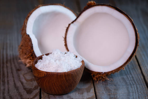 istock coconut split in two halves and flakes in bowl 947195846