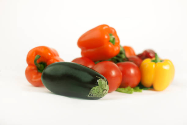 Close-up View at the Fresh and Delicious Organic Tomatoes, Cucumbers and Yellow Chili Peppers at the Farmers Market. The Tomato is the Edible, Often Red, a Berry of the Plant Solanum Lycopersicum.