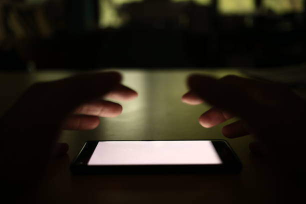 istock White screen mobile phone. social Internet smartphone addiction concept. man reaching for smart phone. 947196908