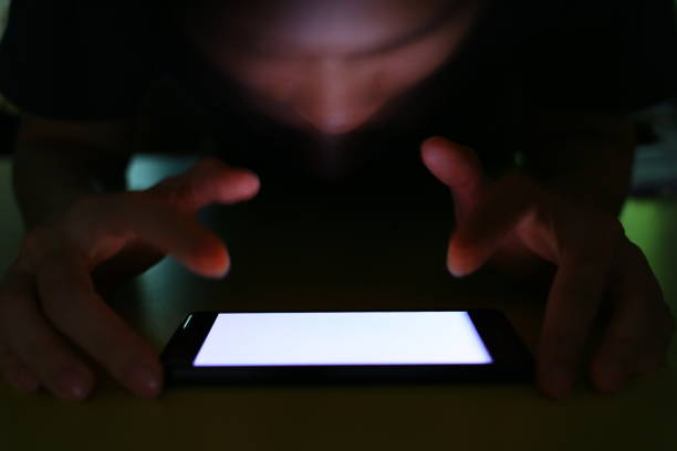istock White screen mobile phone. social Internet smartphone addiction concept. man reaching for smart phone. 947196912