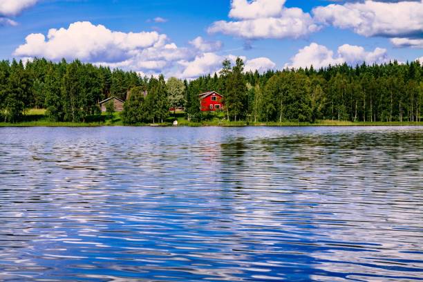 a traditional finnish wooden cottage with a sauna and a barn on the lake shore. summer rural finland. - finland sauna lake house imagens e fotografias de stock