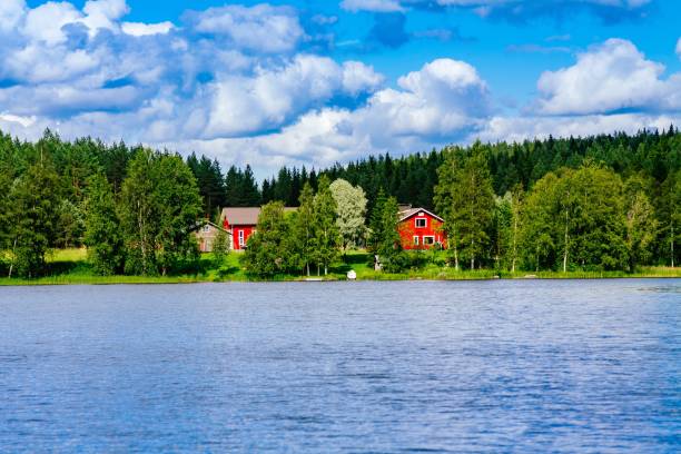 a traditional finnish wooden cottage with a sauna and a barn on the lake shore. summer rural finland. - finland sauna lake house imagens e fotografias de stock