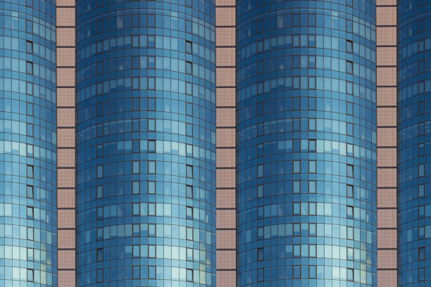 istock A multi-storey brick building under construction, against a blue sky background. High multi-story building. Skyscraper. Blue windows. Mirror 947212614