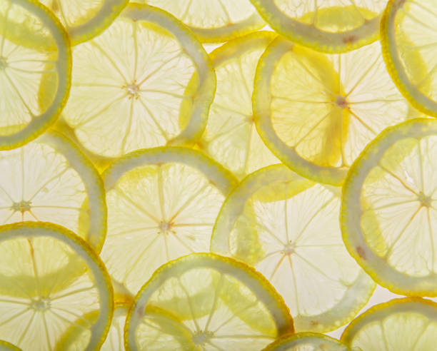 istock Bright fresh lemon slices, back light transparent fruit 947212728