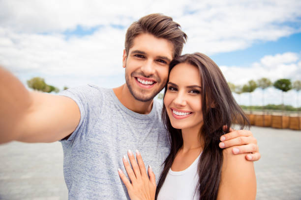 Loving Cheerful Happy Couple Taking Selfie In The City Stock Photo - Download Image Now - iStock