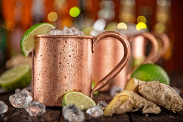 Cold Moscow Mules - Ginger Beer, lime and Vodka on bar Cold Moscow Mules - Ginger Beer, lime and Vodka on bar, close-up. Gin stock pictures, royalty-free photos & images
