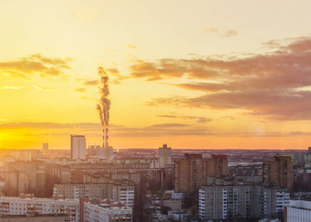 Environmental problem of environmental pollution and air in large cities. Sunny sunset. Air pollution. The city from above
